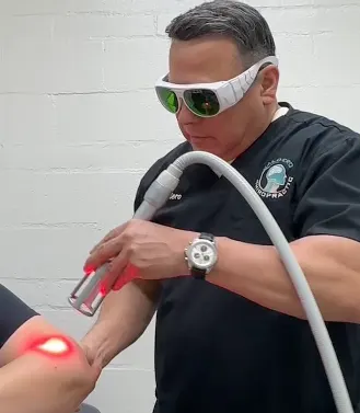 Dr. Caldero applying Class IV laser therapy